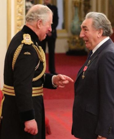 Son Jim is receiving an award from the British Empire
